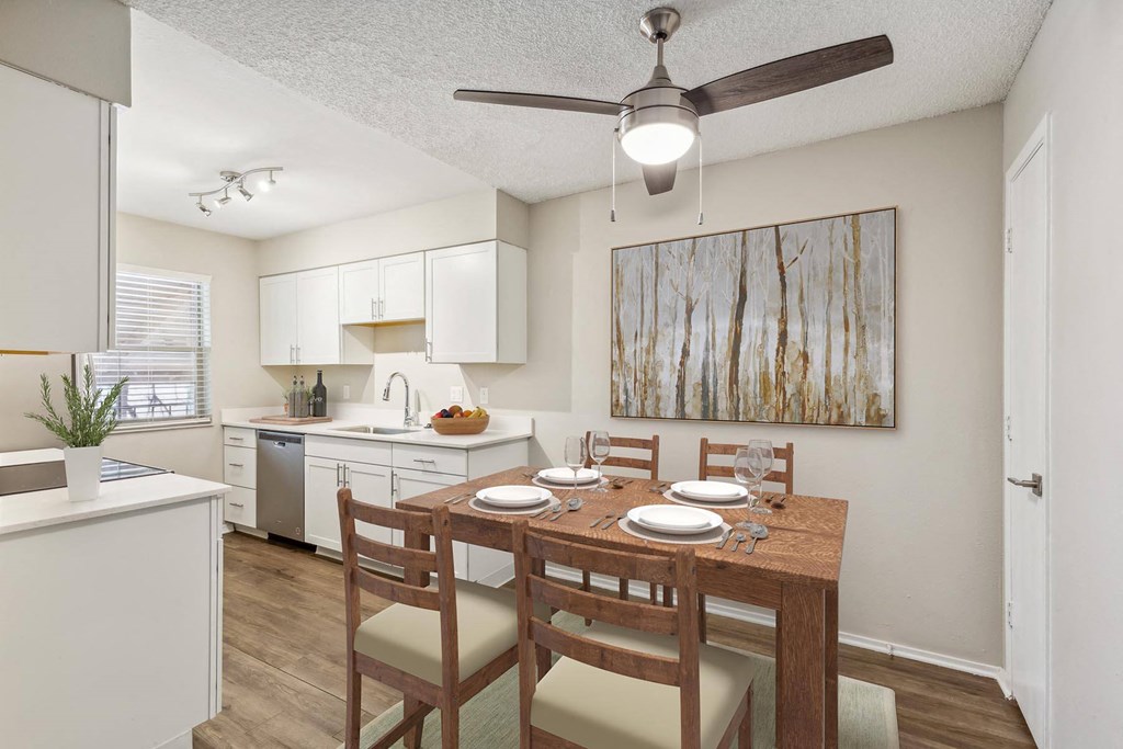 an open kitchen and dining room with a table and chairs at Acacia Gardens, Albuquerque, NM